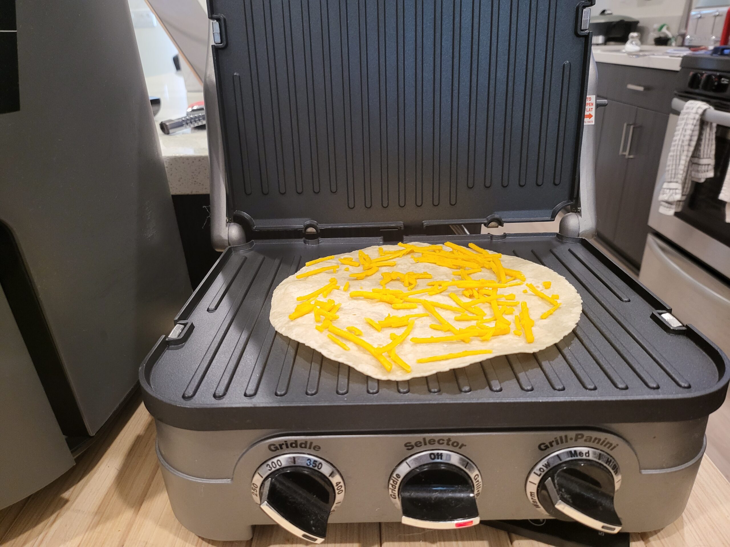 gluten free tortilla with dairy free cheese in panini press
